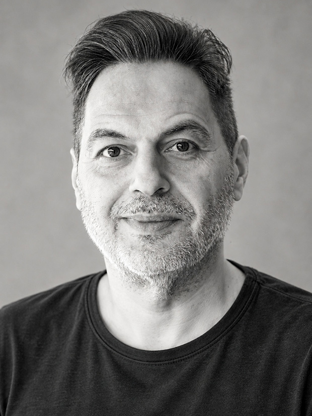 Black-and-white portrait of George Kousagiannidis, founder of Enmedia.